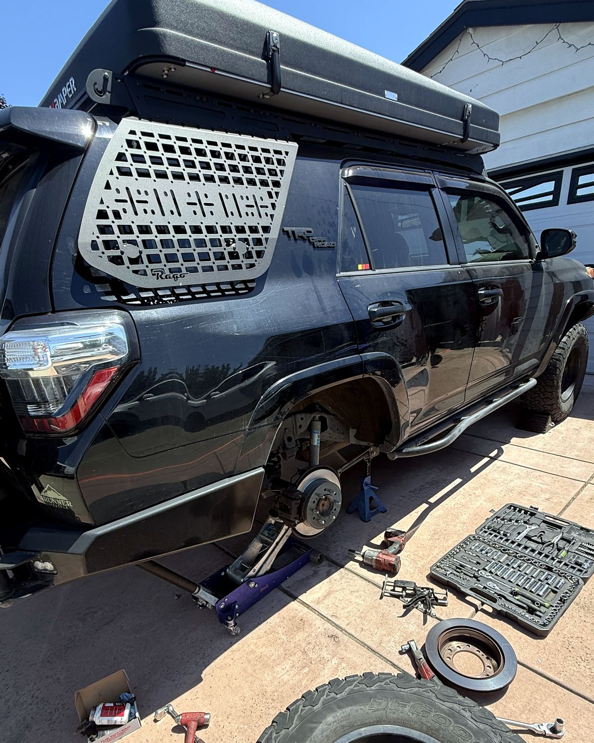 Stewart Mobile Repair replacing brakes on an SUV in a customer's driveway
