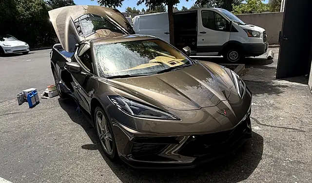 Chevrolet Corvette C8 with the front trunk open during a mobile service visit in a Bay Area parking lot