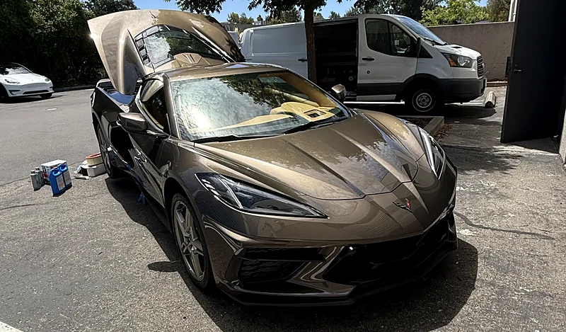 Chevrolet Corvette C8 with the front trunk open during a mobile service visit in a Bay Area parking lot
