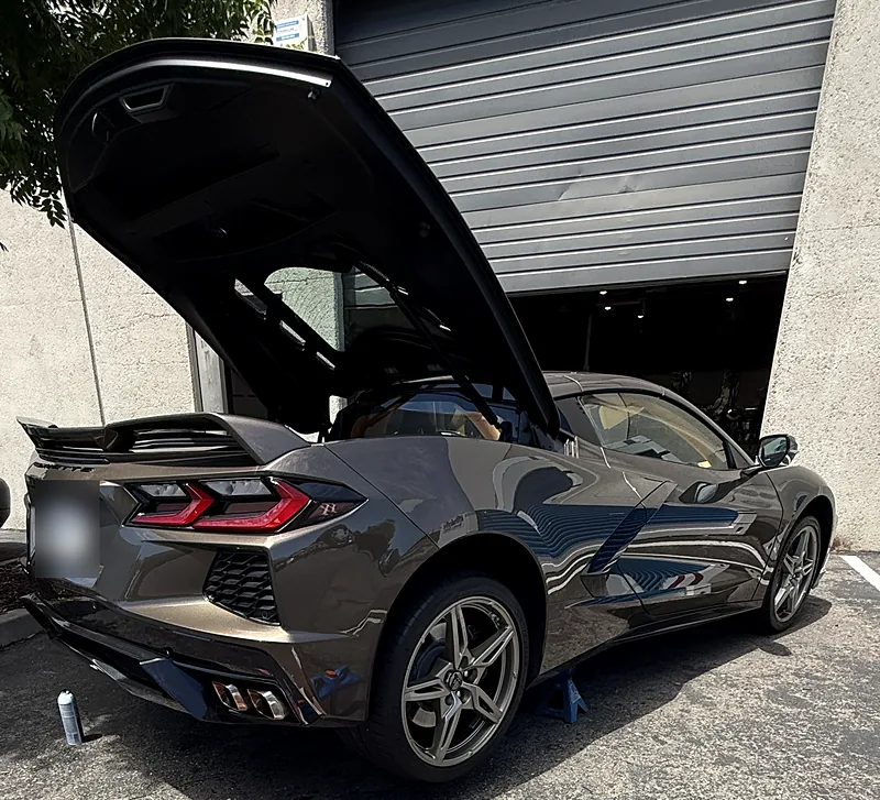 Chevrolet Corvette C8 with the rear engine cover open, parked for a mobile service visit